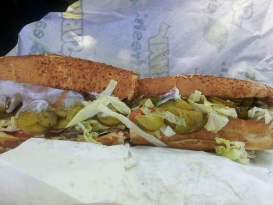 Freshly toasted Italian herbs and cheese bread, chicken beacon ranch sandwich, with lettuce, tomato, chipotle sauce, and pickles