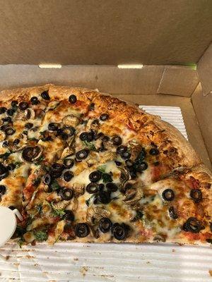 Pizza with mushrooms, olives and spinach