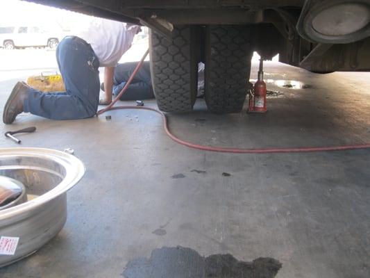 This isn't *just* a flat tire, it seems -- and not afraid to get their white shirts dirty.