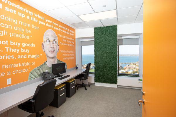 Orange room with a mural of quotes from marketing leader, author and entrepreneur Seth Godin