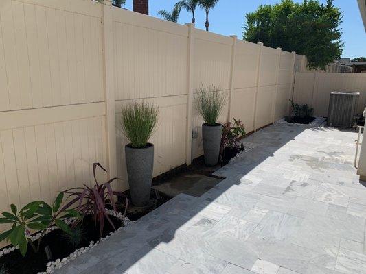 Irrigation drip lines installed into the planters from underneath and continuation into planter bed on both sides. Impeccable job.