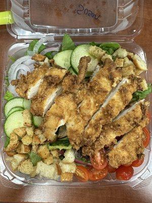 Hand-breaded chicken over the garden salad. So yummy! The very best salad I can get in the area. Love this place!!!