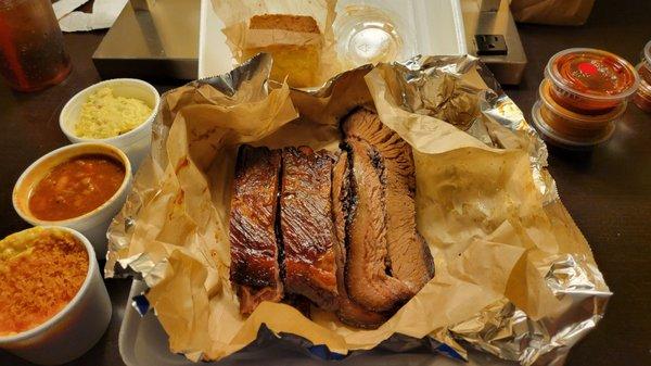 4 ribs, several slices of brisket, mac-n-cheese, beans, potato salad, corn bread and multiple types of sauce!