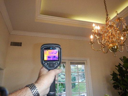 Wall and ceiling were wet from roof leak. Only visible with thermal camera.