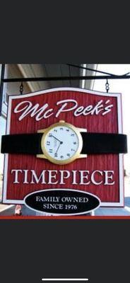 McPeek's Timepiece Sign hanging in front of store