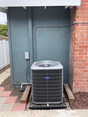 Heat pump condenser; requisite drain, fuse box, and cable channel.