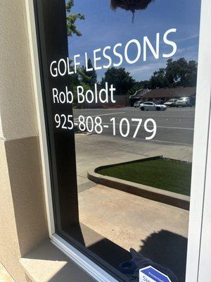 East Bay school of golf window with my phone number on it