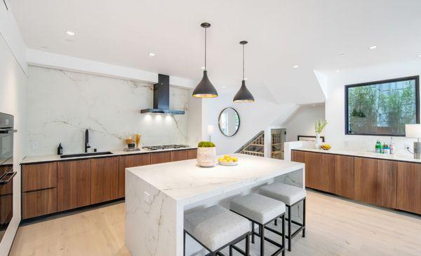 Leicht Kitchen with a ribbed walnut door called Bossa. Black edge pull handles are custom sized and powder-coated