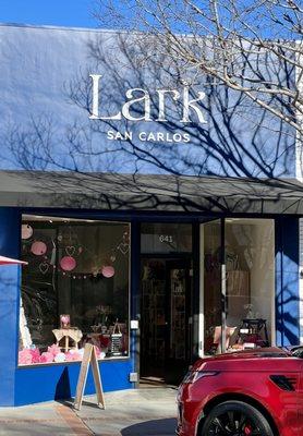 Front of the store, windows decorated for Valentines Day.