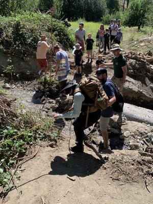 Holding onto a rope to go across a mini creek (Sep 2023)