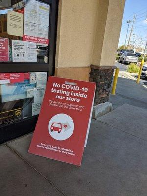 Social distancing practices, guidelines, policies and covid-19 vaccine instructions signs in front of CVS.