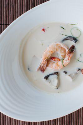 Shrimp in silky coconut galangal soup with young coconut meat, shiitake and straw mushrooms