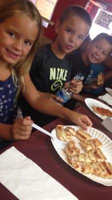 The kids enjoying their slices