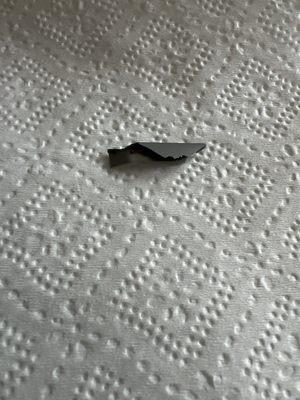 Piece of plastic found in a cake. Very sharp edges!