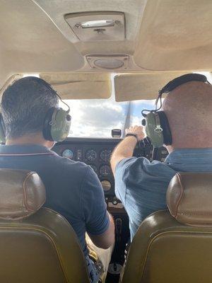 I sat in the back and took pictures, my dad flying and Eusebio instructing him.