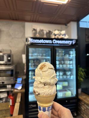 Vanilla peanut butter & chocolate covered strawberry ice cream on a cone