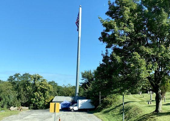 The food bank is located near a flag pole.