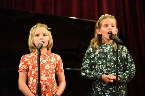 Sisters sing at the Paloma Vocals Winter Recital