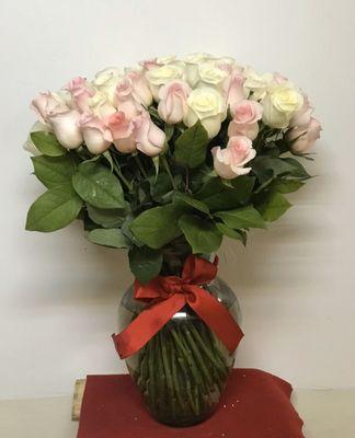 Pink and white roses in a glass vase