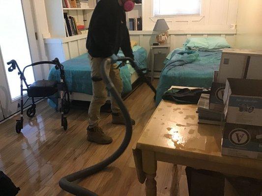 Here our crew is extracting standing water from a hardwood floor.