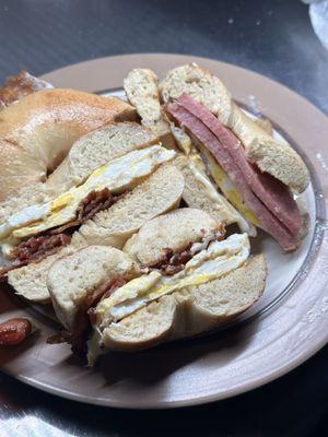 One bacon and one pork roll egg and cheese bagel sandwich