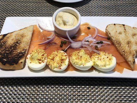 Smoke salmon and eggs appetizer with garlic aioli