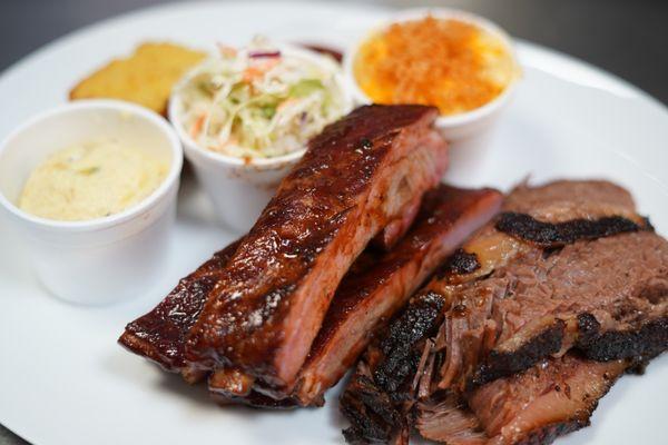 Juice brisket and pork ribs paired with mac n cheese, coleslaw and potato salad