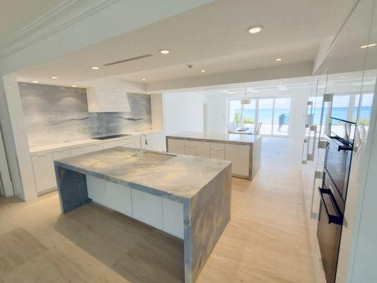 Beautiful kitchen with two islands and full backsplash. Natural stone.