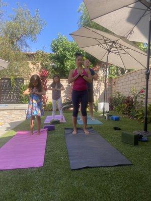 Family yoga session in the backyard.