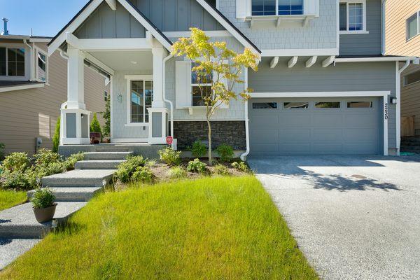 New landscaping provides a welcoming entrance and walkway area, while helping frame the home's architectural design cues.