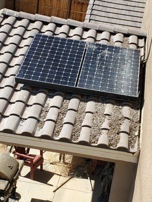 This is Just 2 of the 32 solar panels on my roof.  Note the pigeon droppings and my patio below.