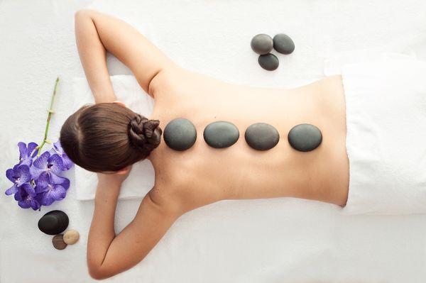 Hot stone massage therapy helps melt away tension, ease muscle stiffness, and increase circulation and metabolism.