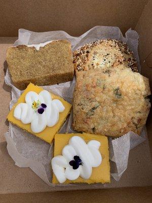 Top left going clockwise: Olive Oil cake, everything scone, cheddar scone and two lemon bars.