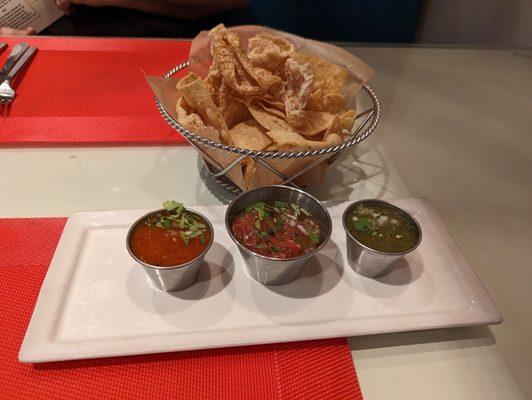 Complimentary chips and chicharrones with 3 types of salsa.