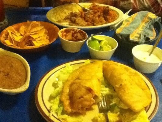 Shrimp empanadas, filet of fish w/ranchera sauce, ships & salsa, and beans.