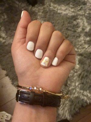 White gel manicure with gold accent.