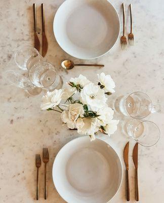 An elegant modern look with our Castle White dinner plate, Brushed Gold flatware and Modo glassware