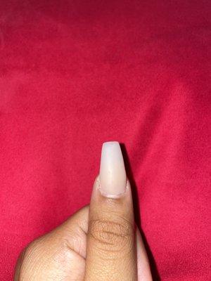 Uneven shape :/ "coffin" shape. And acrylic on the side of my nail on my skin.