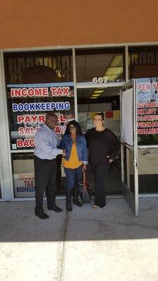 Ms. Sheri Brown being congratulated by Tunde Shodiya and Claribel Carbajal of Chief Tax Services