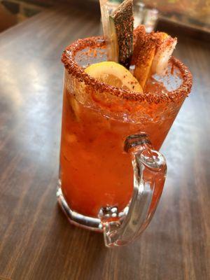 Their Famous Traditional Michelada with a shrimp and citrus medley garnish.