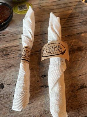 Eating utensils are wrapped inside a napkin.