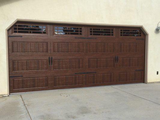 Double garage door double insulated with Prairie Window trim Walnut color finish with exterior carriage house accents