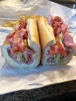 Sharp Dressed Italian: Prosciutto, capicola, genoa salami, aged sharp provolone on a fresh roll w/ lettuce, tomato, onion, oil & spices