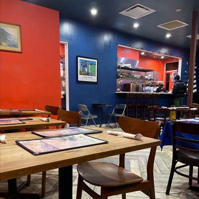 View of the kitchen from table at back of restaurant