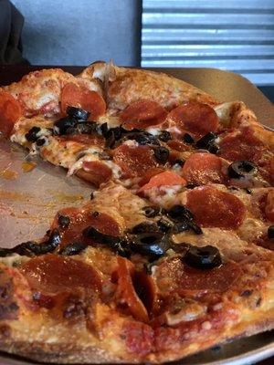 Pepperoni pizza with black olives