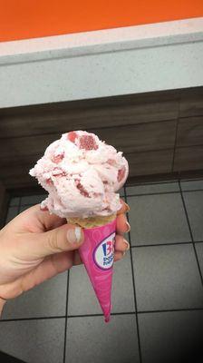 strawberry scoop in a sugar cone