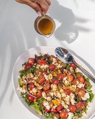 Greek Salad * made with arugula, mixed greens, cherry tomato, marinated olives, cucumber, red onion, sweet bell pepper, crumb...