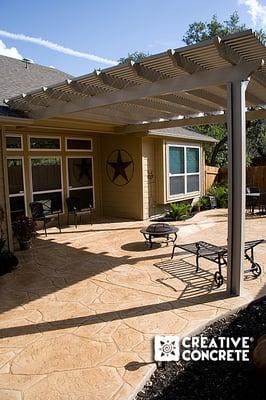 Stamped concrete patio with aluminum pergola by Creative Concrete ®.