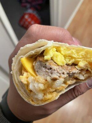 Breakfast burrito with cold tater tots and cheese that isn't melted.