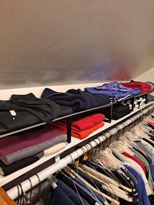 acrylic shelf separates sweaters in tight area